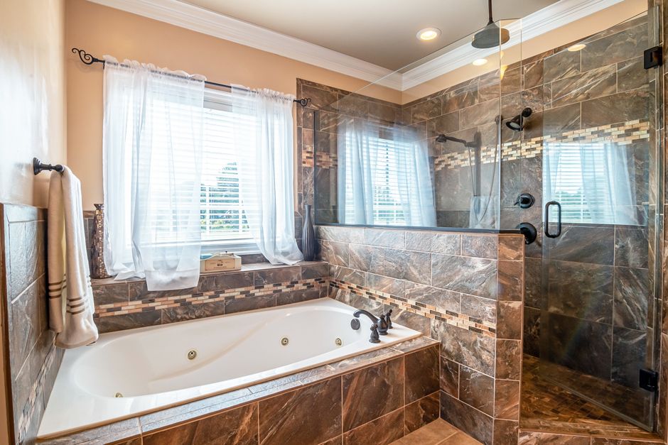 Elegant bathroom with jetted soaking tub and glass-enclosed shower