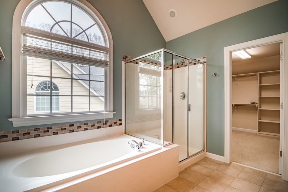 Master bathroom with soaking tub and glass shower stall