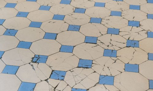 Cracked and worn octagon tile flooring showing signs of damage