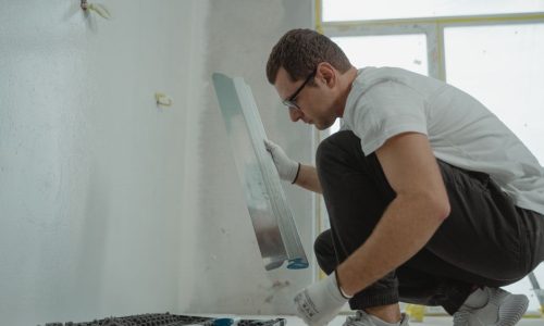 Contractor applying plaster during a bathroom renovation