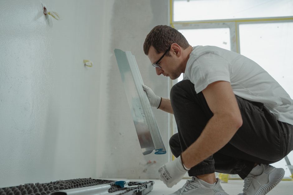 Contractor applying plaster during a bathroom renovation